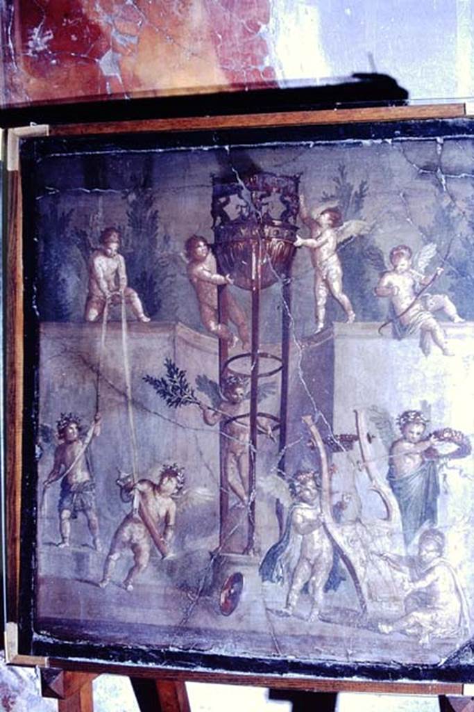 V.17, Herculaneum, 1968. Painting found in the centre of the north wall of an upper room. Photo by Stanley A. Jashemski.
Source: The Wilhelmina and Stanley A. Jashemski archive in the University of Maryland Library, Special Collections (See collection page) and made available under the Creative Commons Attribution-Non Commercial License v.4. See Licence and use details. J68f1843
According to Pesando and Guidobaldi, -
“This picture, inserted into a wooden frame, was a rare example of picturae excisae ….inclusae in ligneis formis, (Vitruvio, II.8) created by shops and then incorporated into specialized frescoed walls.”
See Pesando, F. and Guidobaldi, M.P. (2006). Pompei, Oplontis, Ercolano, Stabiae. Editori Laterza, (p.355)
See Maiuri, Amedeo, (1977). Herculaneum. 7th English ed, of Guide books to the Museums Galleries and Monuments of Italy, No.53 (p.48).